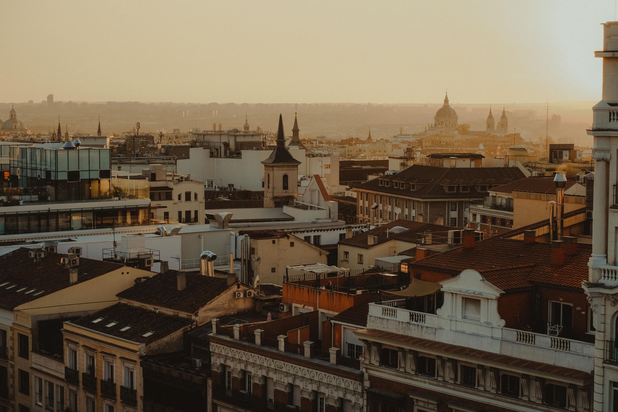 Rooftop terrace overlooking Madrid's Royal Palace at dusk